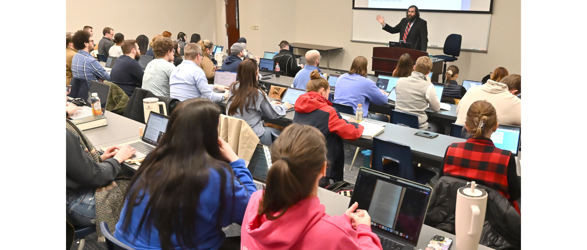 Students working in campus library computer room