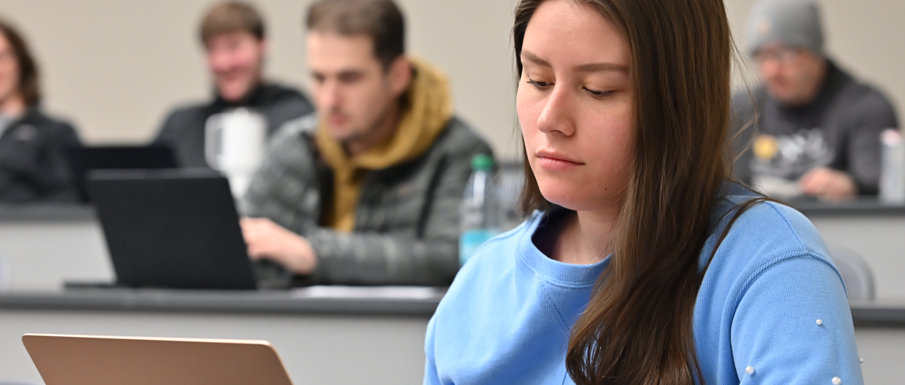 Students laughing and working together on campus